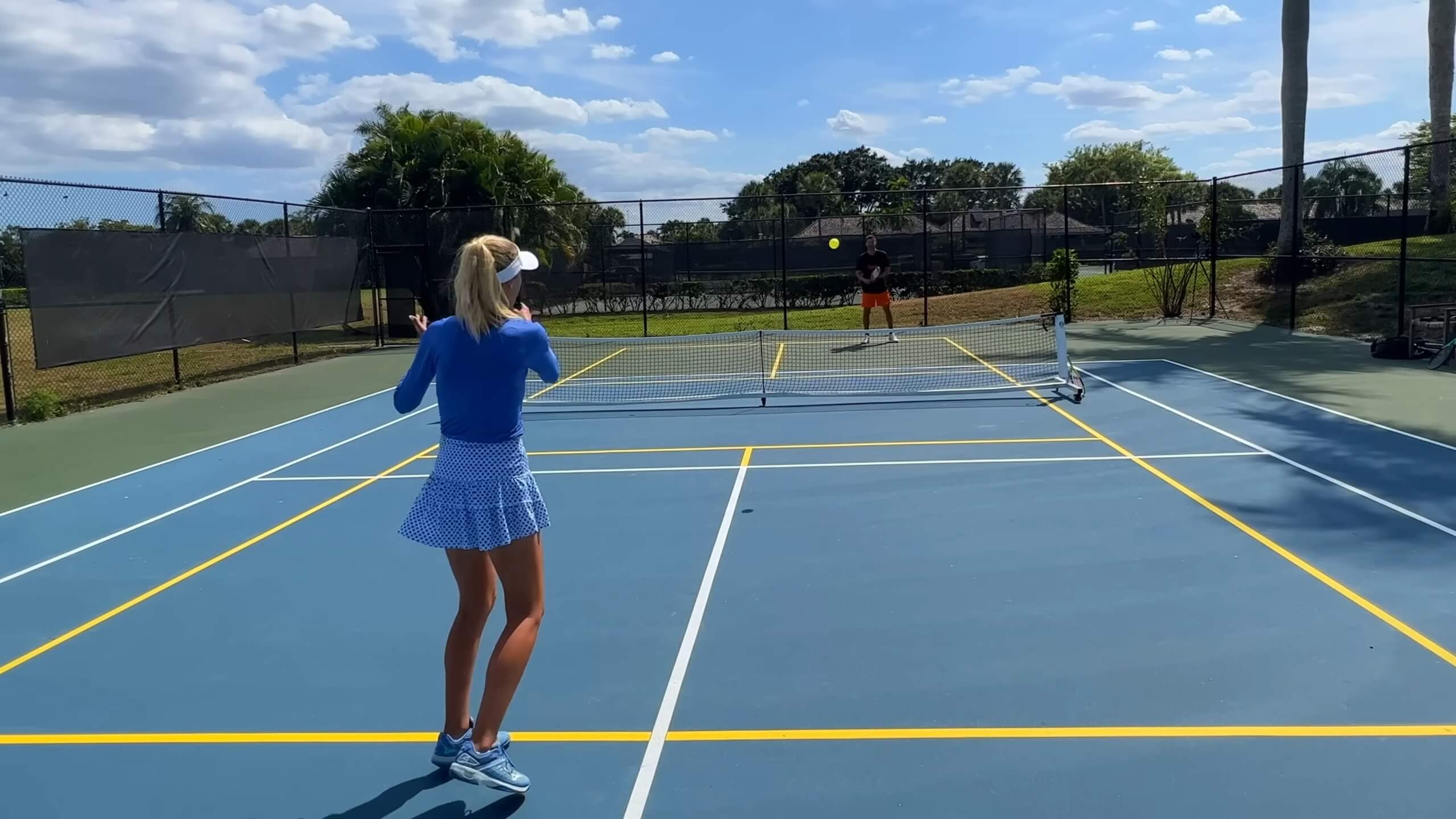 The girl and the boy are playing pickleball